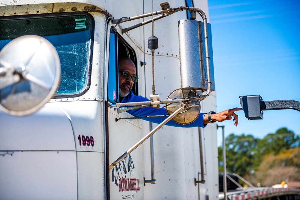 Man in semi trailer parking at Mile Marker Parking