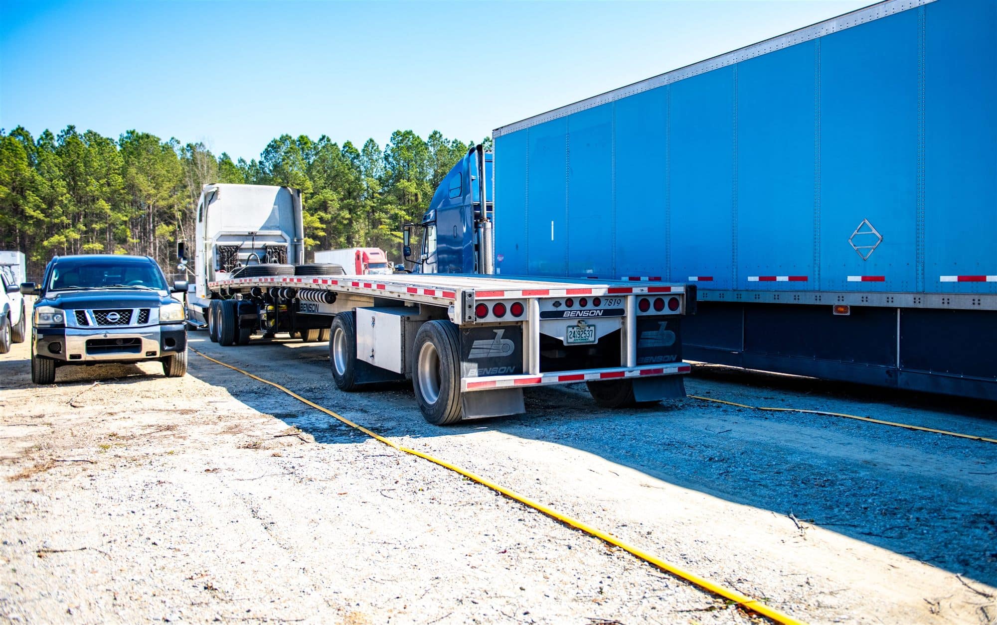 Flatbed trailers parked in secure trailer parking spaces at Mile Marker Parking in Fayetteville, NC
